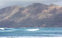 La Caleta de Famara (Teguise), view to the Risco de Famara, image 2.jpg
